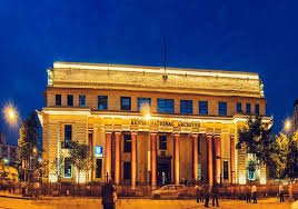 The grand entrance to the Kenya National Archives building in Nairobi, with its distinctive architectural features and lush gardens.